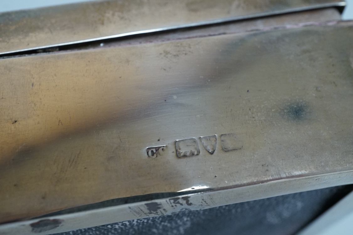 An engine turned silver rectangular cigarette box, 14.1cm and two mid 20th century engine turned silver cigarette cases.